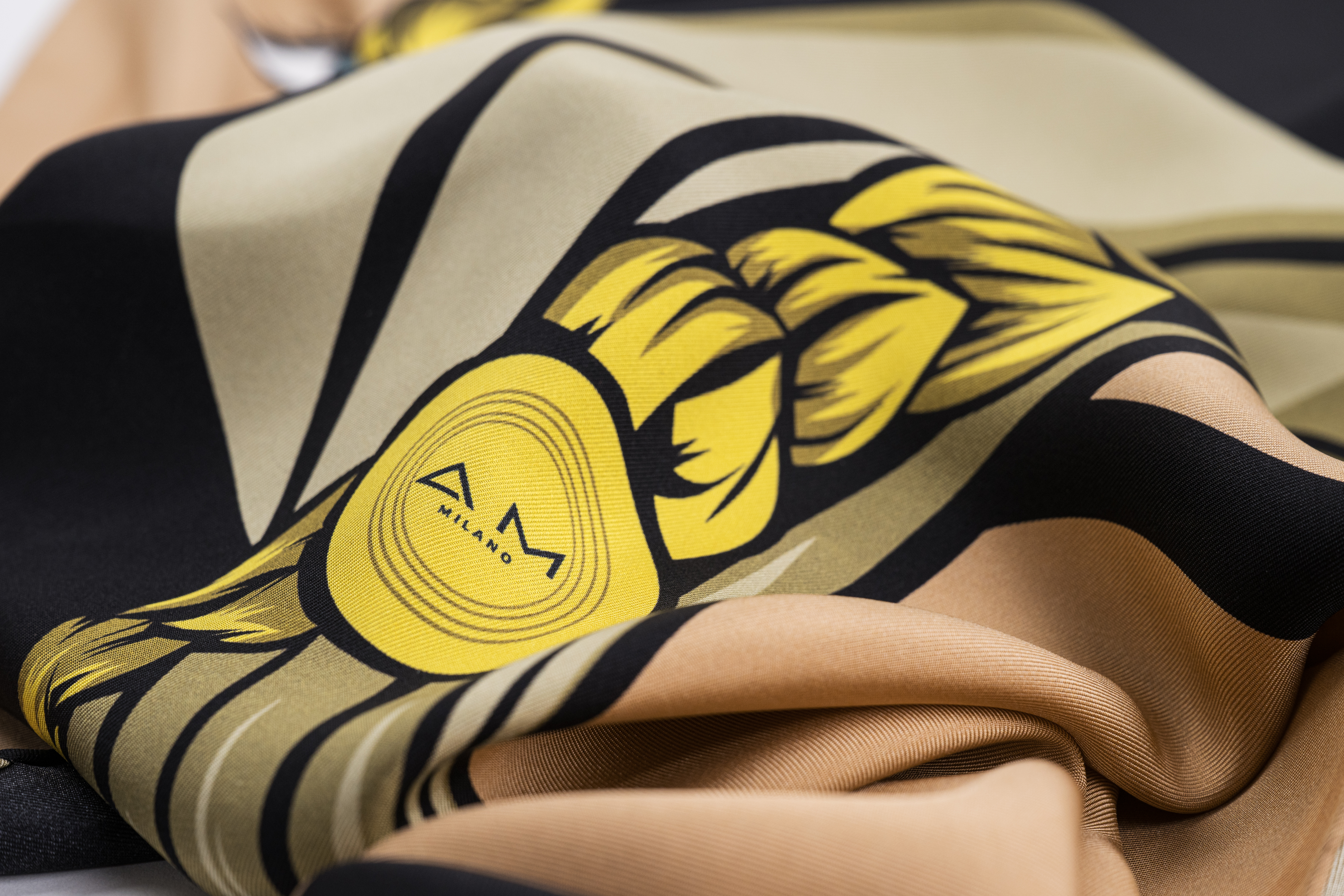 Close-up of a fabric with a yellow and black graphic design.