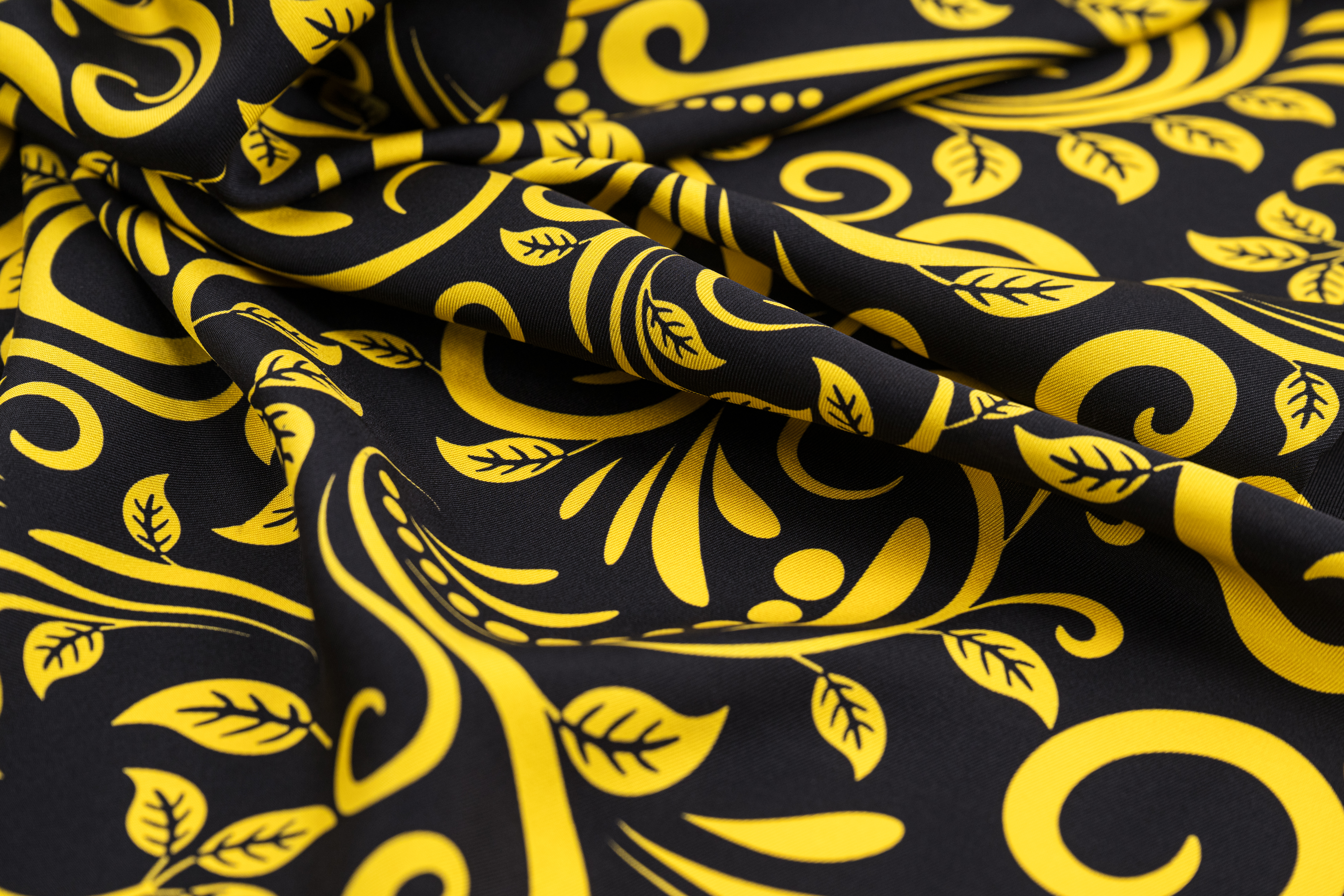 Black fabric with intricate golden floral patterns.