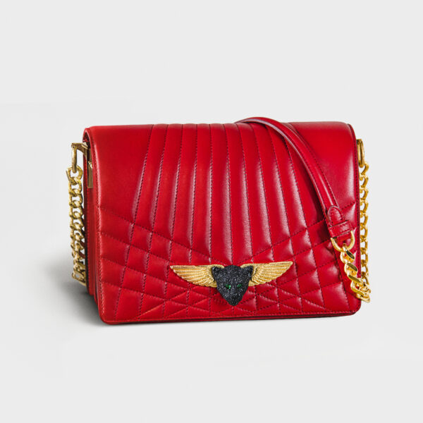 Red quilted leather handbag with gold chain and winged emblem.