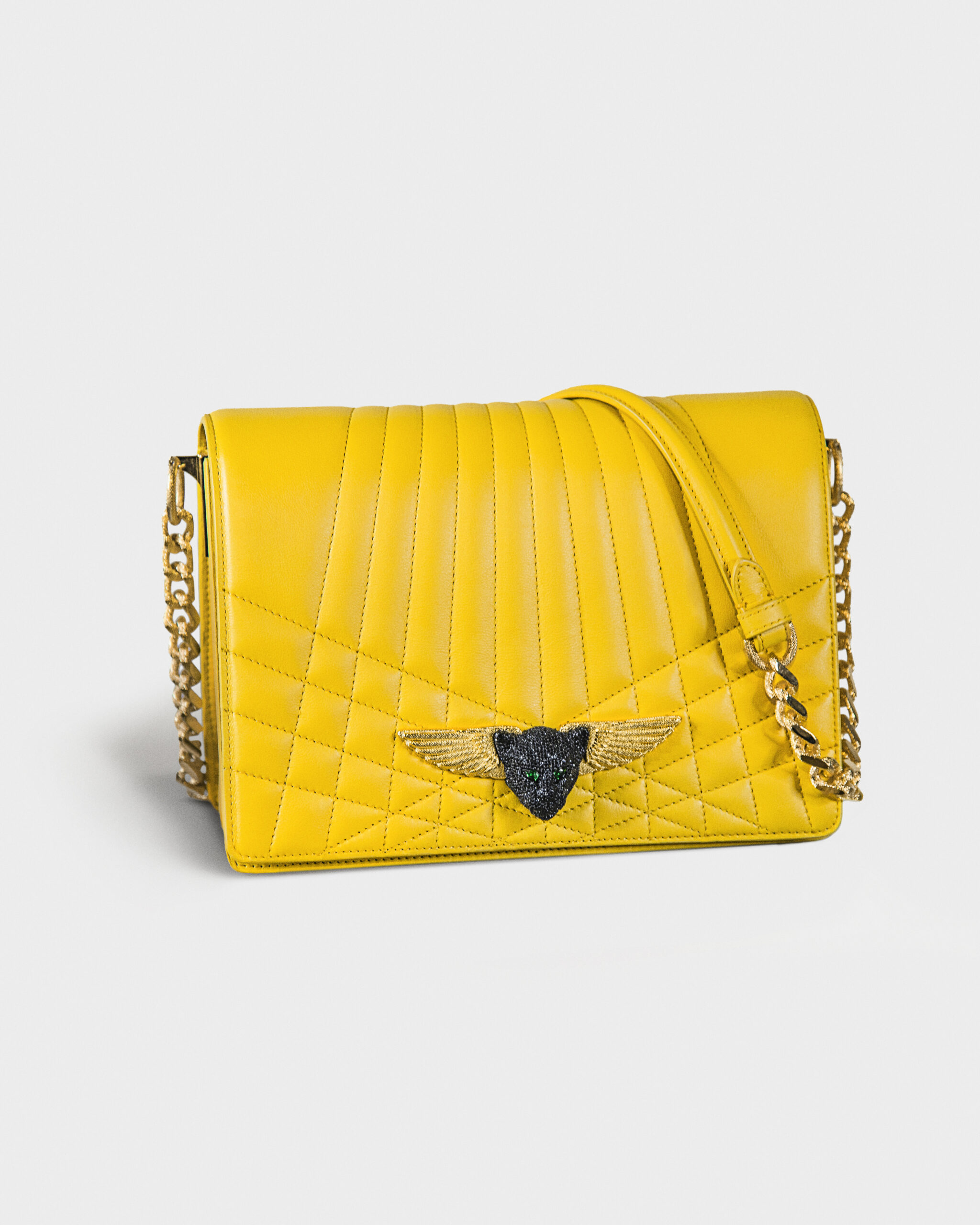 Yellow quilted leather handbag with a gold chain strap and heart-shaped clasp.
