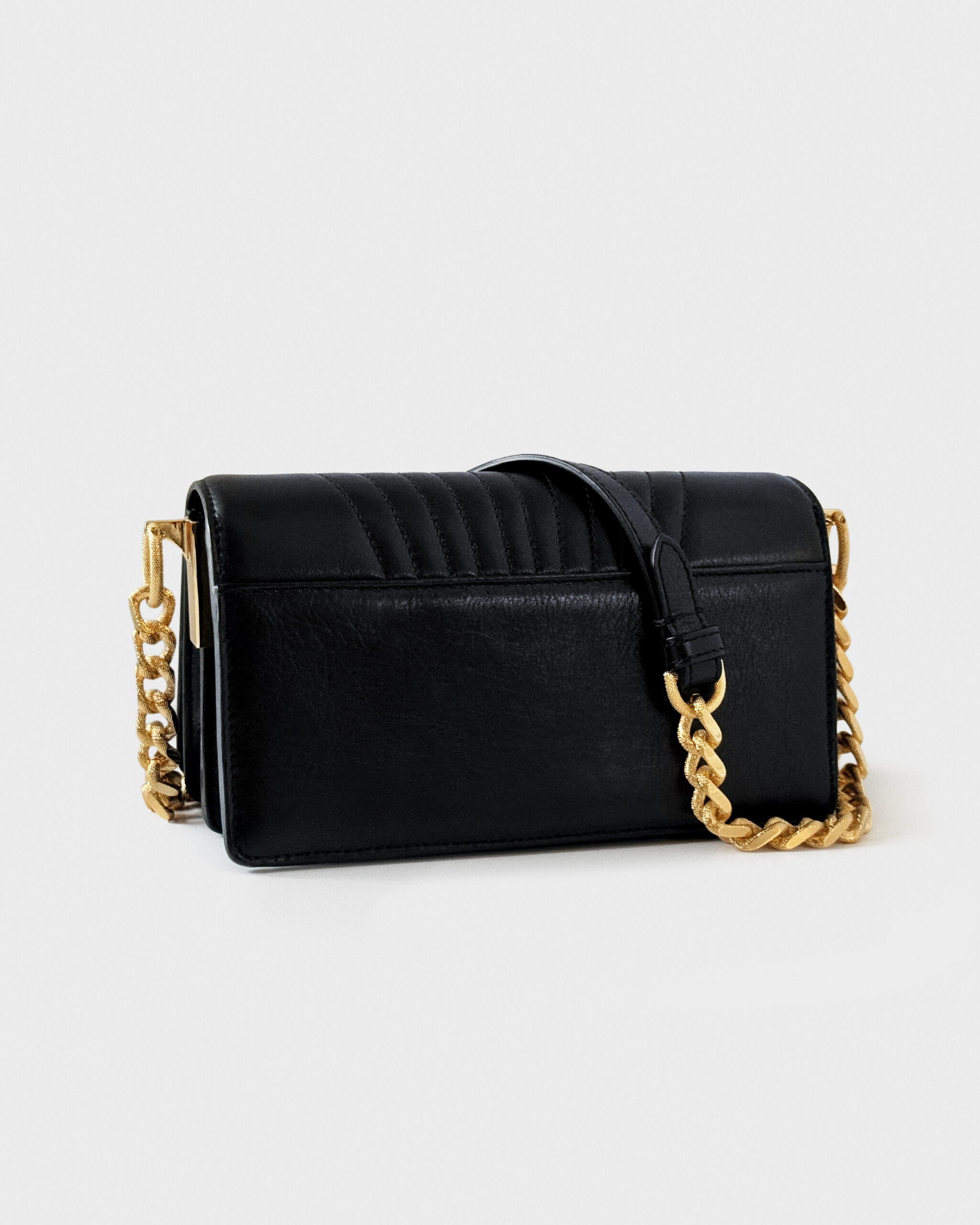 Elegant black leather handbag with gold chain strap.