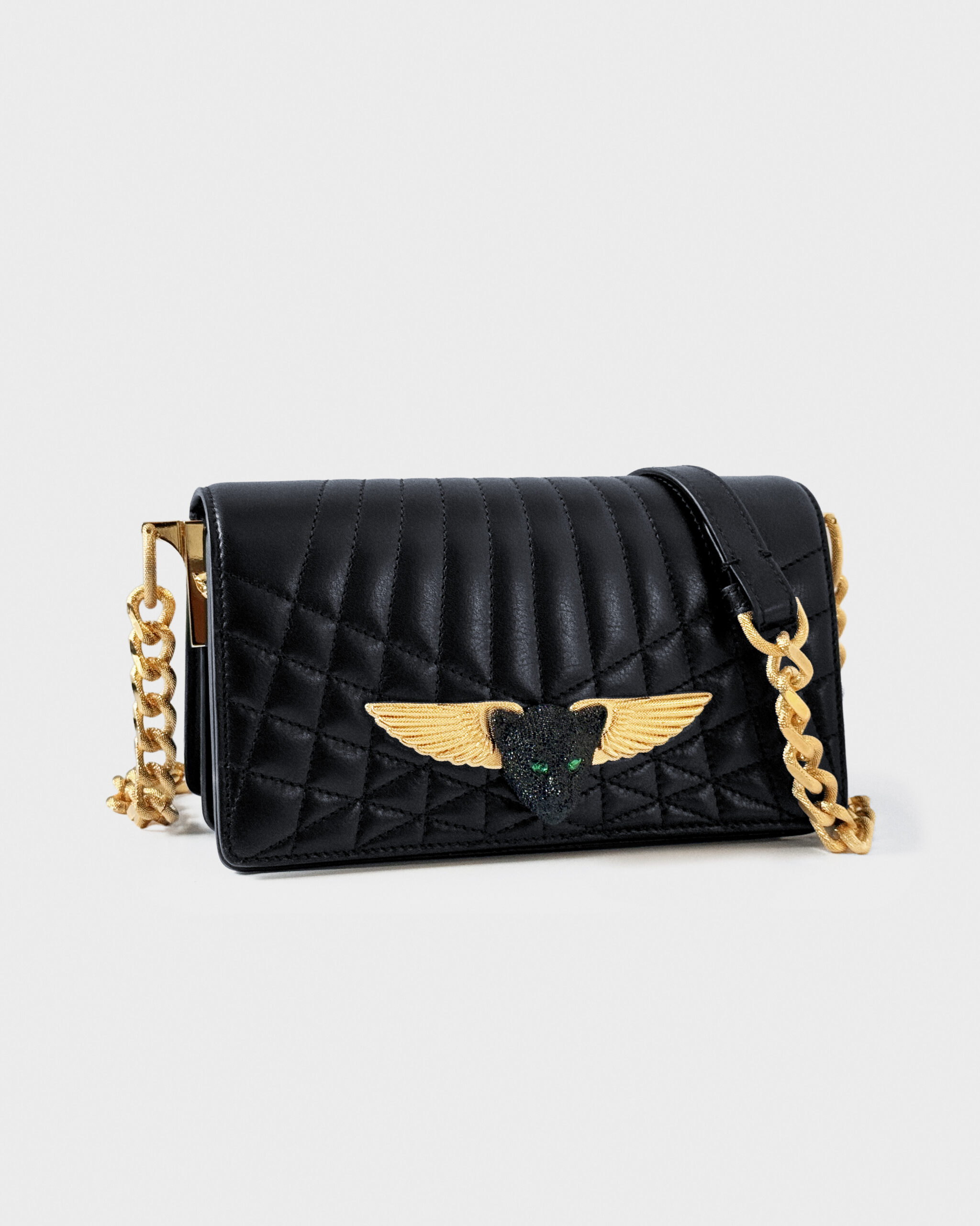 Black quilted handbag with gold winged emblem and chain strap.