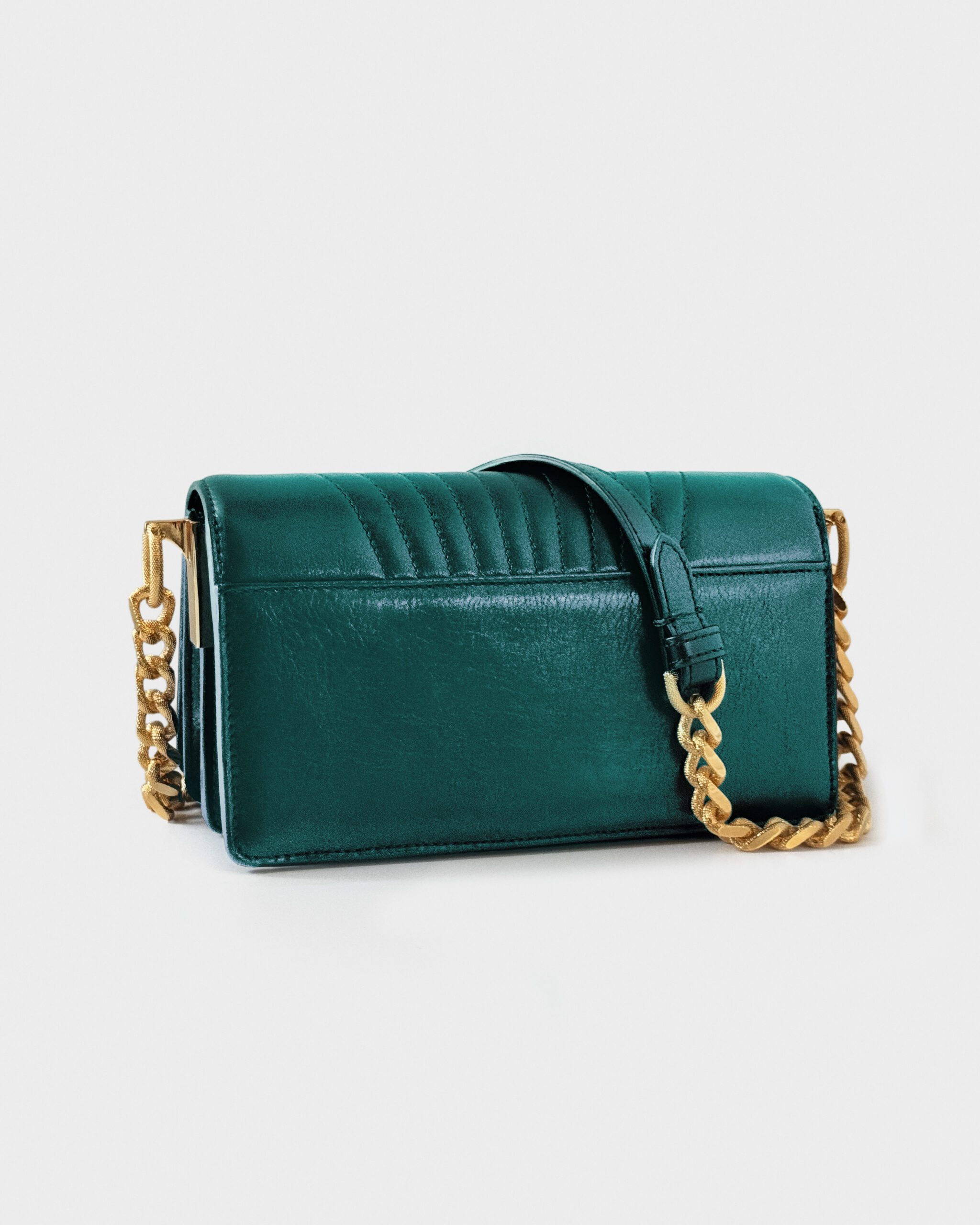 Elegant teal velvet handbag with gold chain strap.