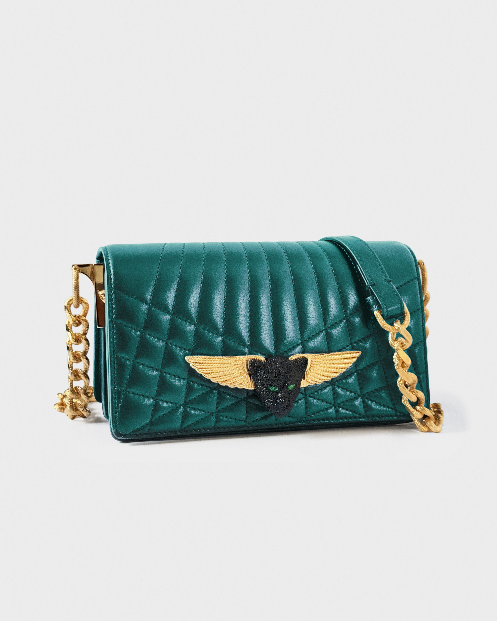 Elegant teal quilted handbag with gold winged emblem and chain strap.