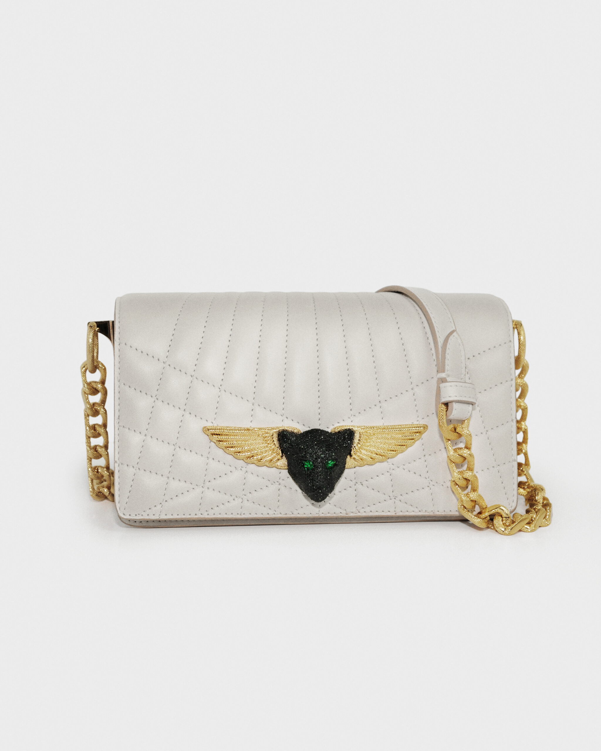 Elegant white quilted leather handbag with gold chain strap and winged emblem.