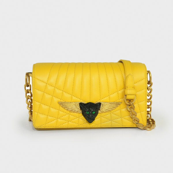 Yellow quilted handbag with winged emblem and chain strap.