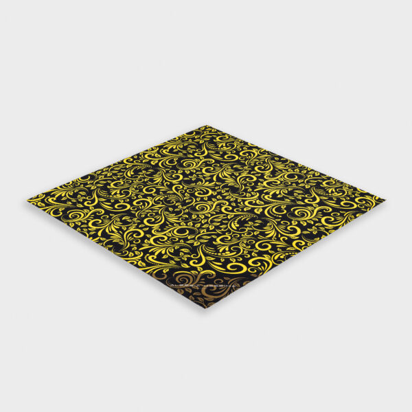 Folded black and yellow patterned fabric with intricate designs.