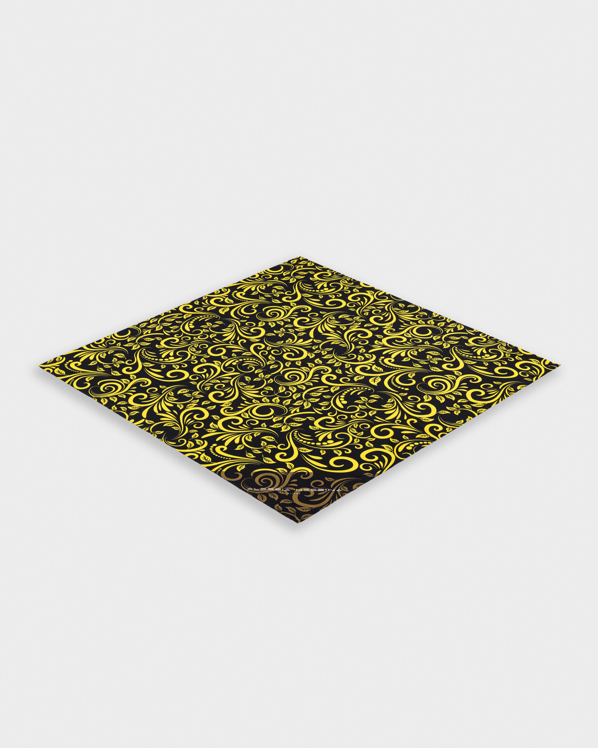 Folded black and yellow patterned fabric with intricate designs.