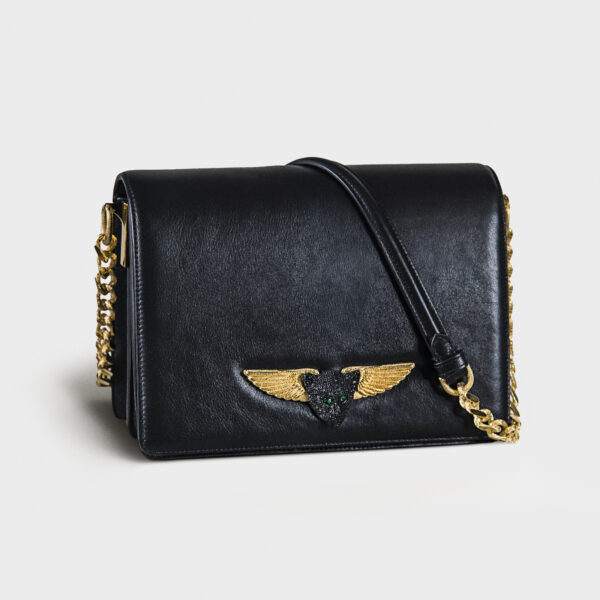 Black leather handbag with gold chain and winged emblem.