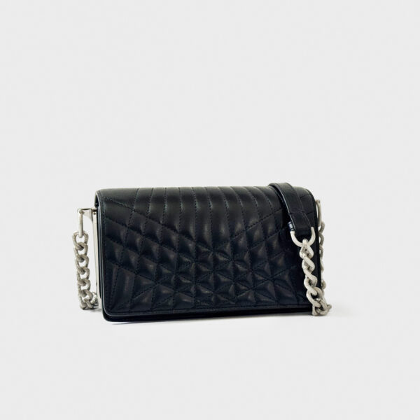 Black quilted handbag with silver chain strap on white background.