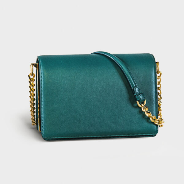 Elegant teal handbag with gold chain strap.
