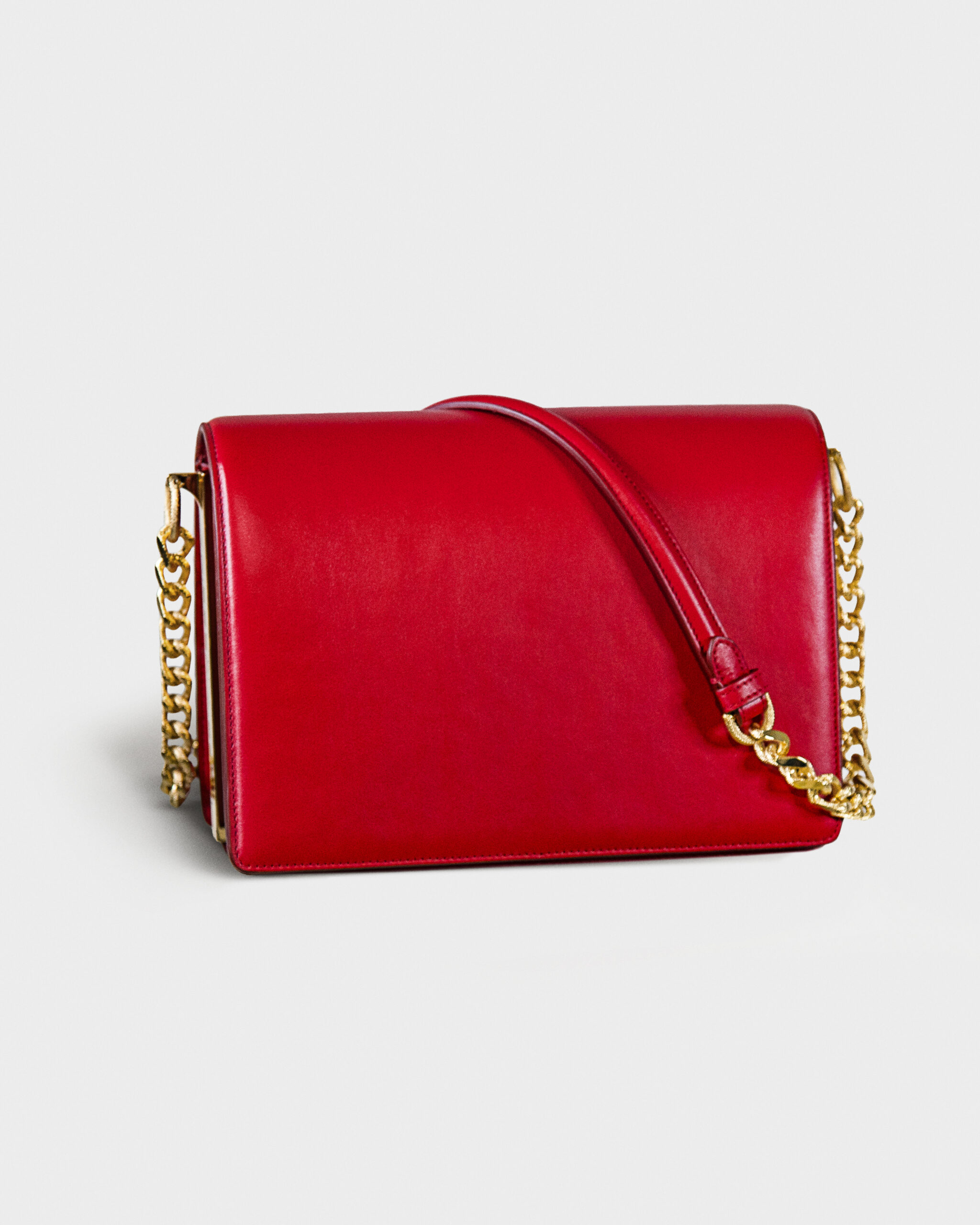 Elegant red leather handbag with gold chain strap.
