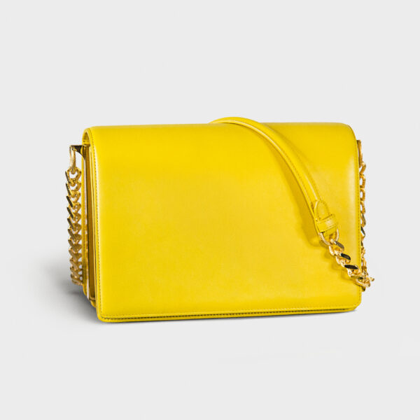 Bright yellow handbag with a gold chain strap.
