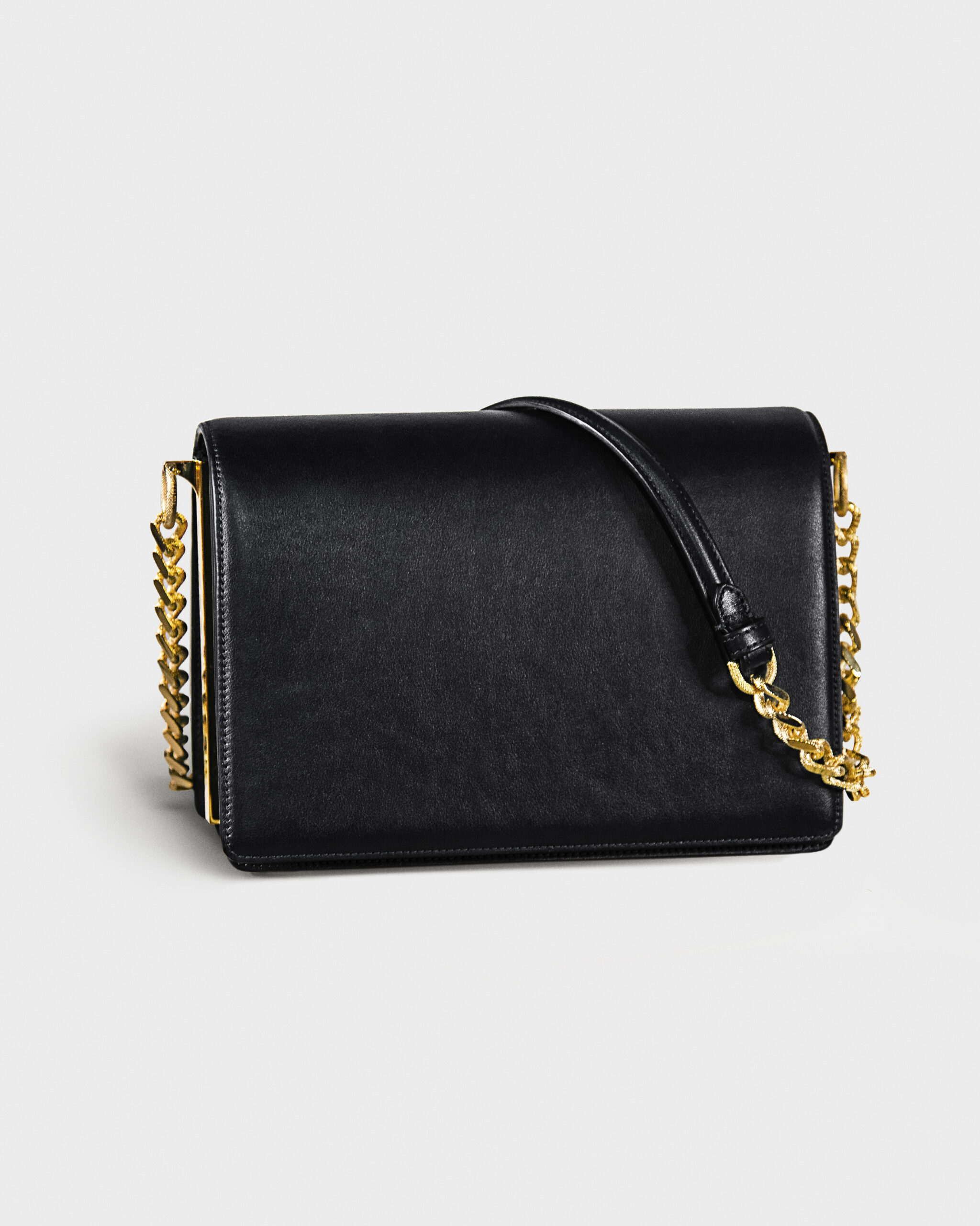 Elegant black leather handbag with gold chain straps.