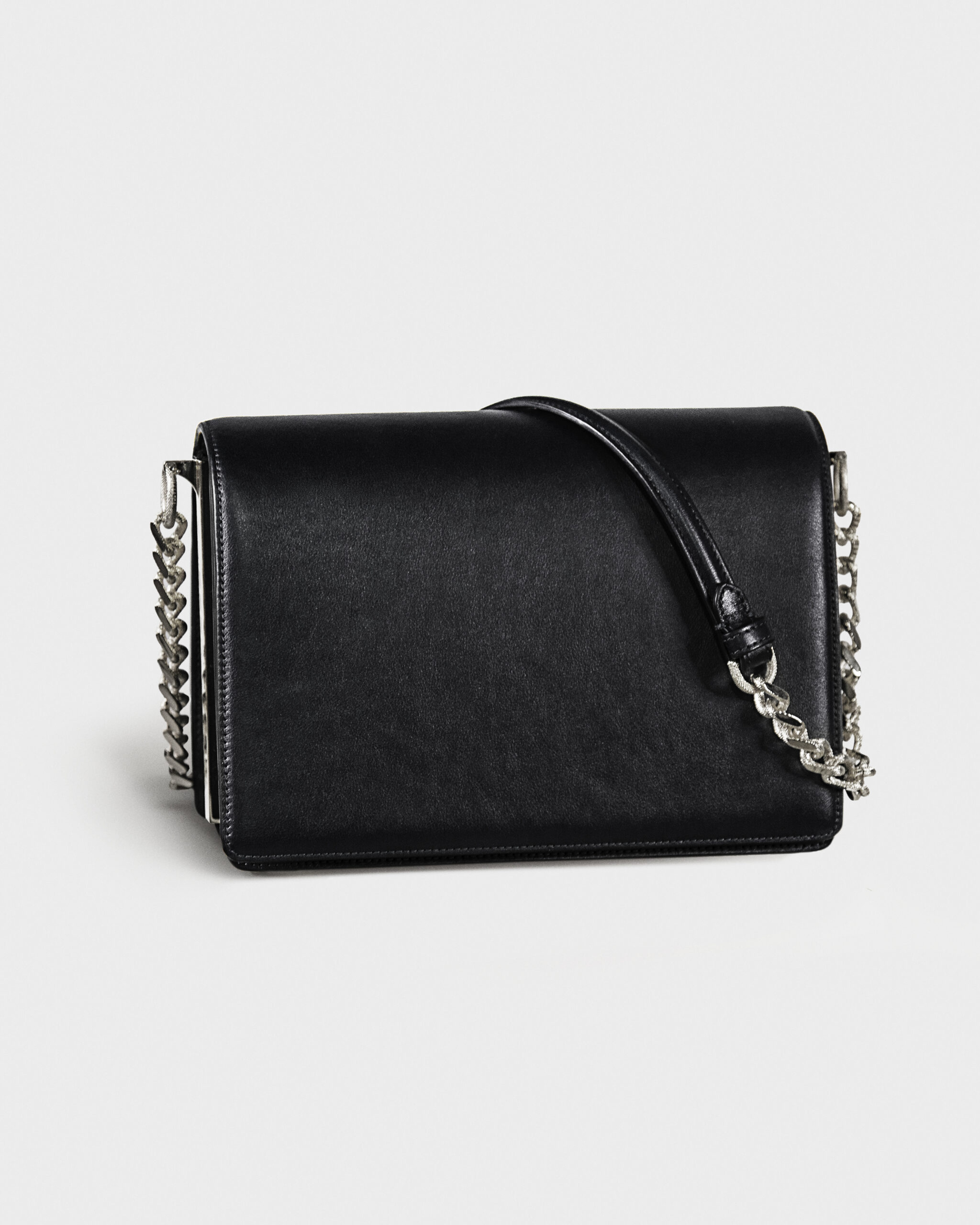 Black leather handbag with silver chain strap on a white background.