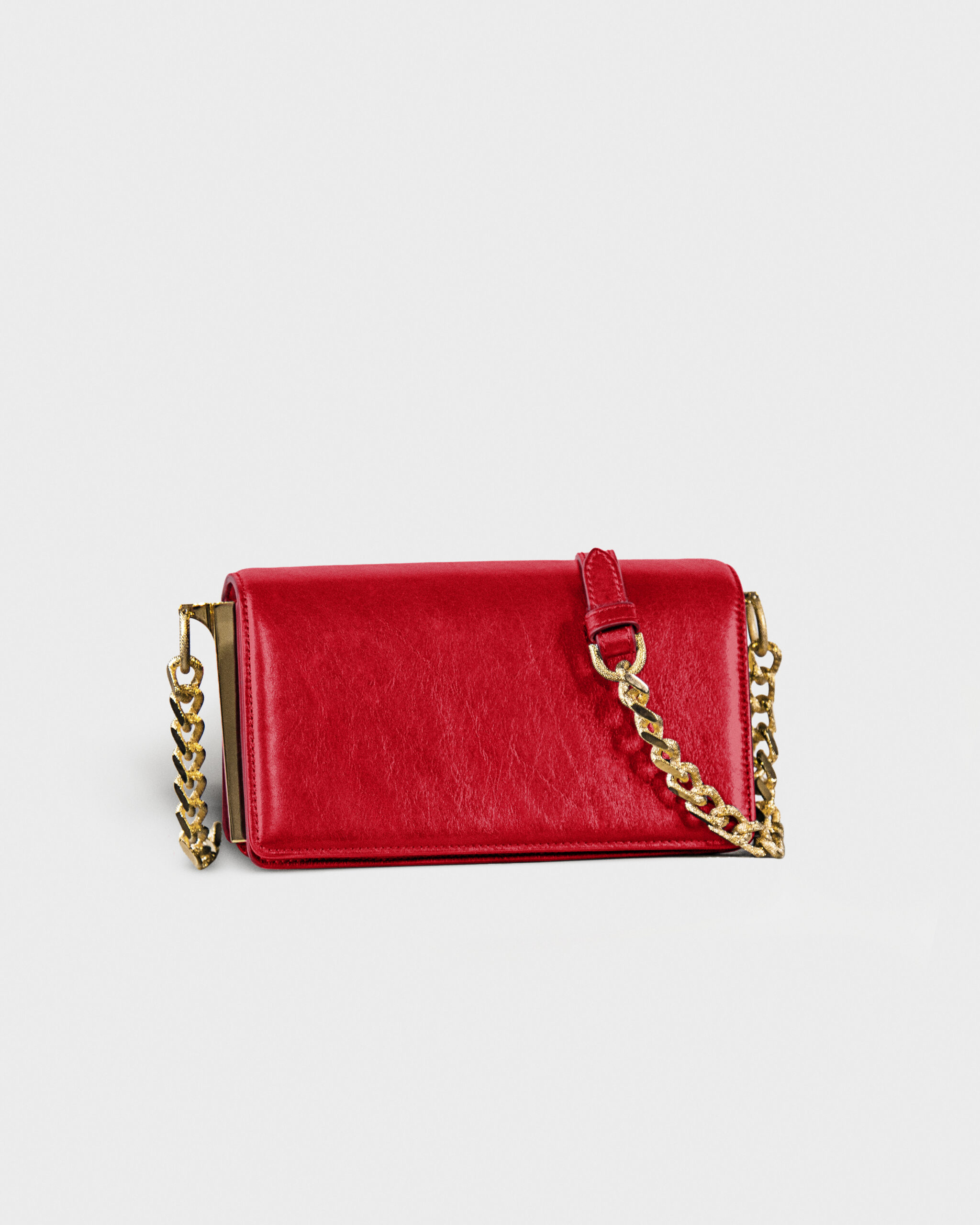 Red leather purse with gold chain strap on white background.
