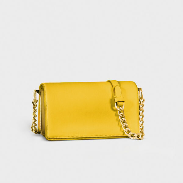 Yellow leather purse with gold chain strap on white background.