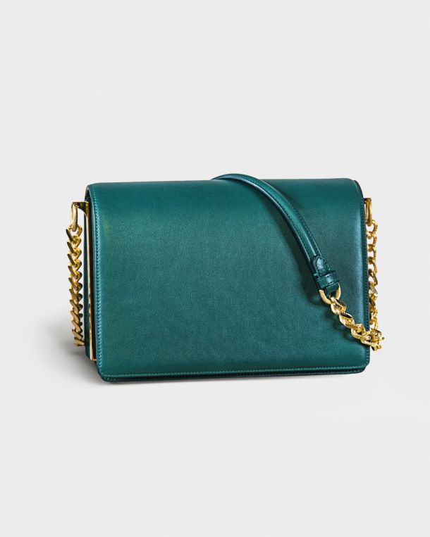 Elegant teal handbag with gold chain strap.