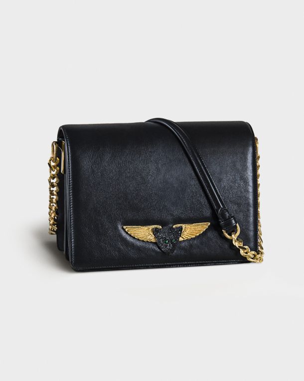 Black leather handbag with gold chain and winged emblem.