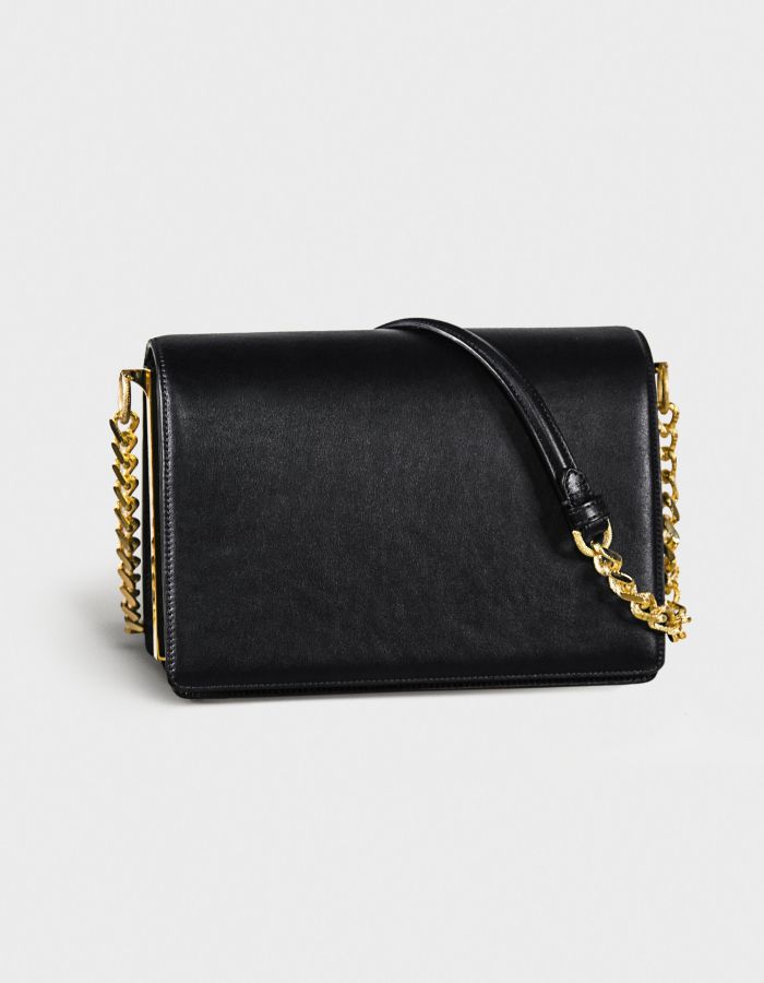 Elegant black leather handbag with gold chain straps.