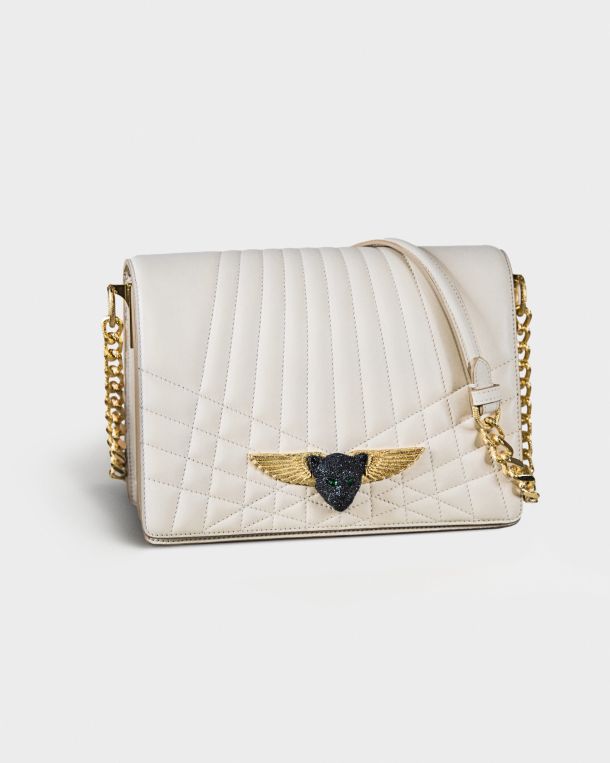 White quilted handbag with gold chain and winged emblem.