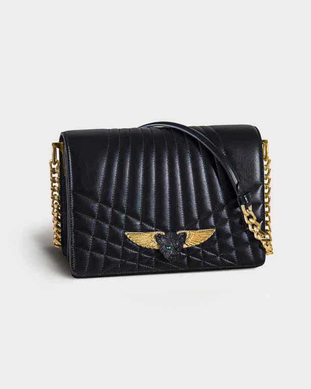 Black quilted leather handbag with gold chain and winged clasp.