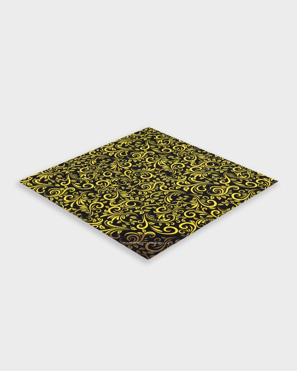 Folded black and yellow patterned fabric with intricate designs.